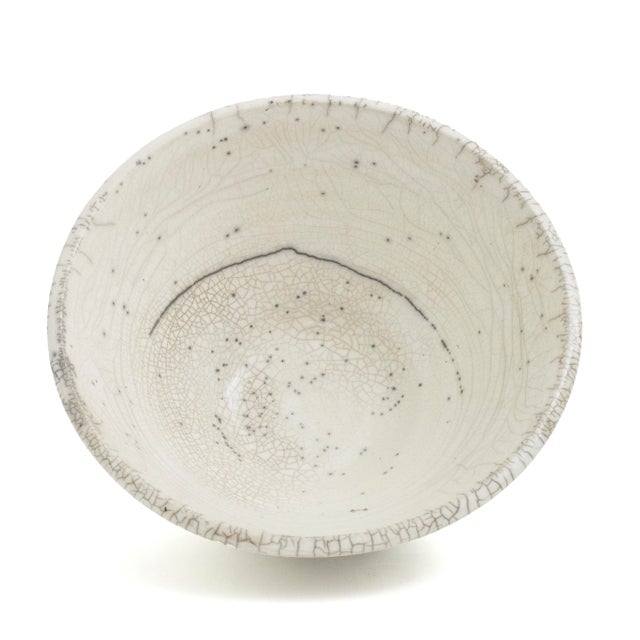 Handcrafted of white ceramic following the ancient Japanese technique of Raku to create an elegant crackled effect, this...