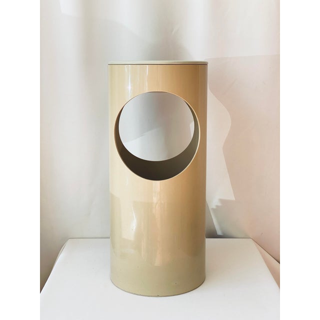 A plastic cylinder with two large openings and a removable tray, intended as an ashtray. Designed by Enzo Mari for Danese...