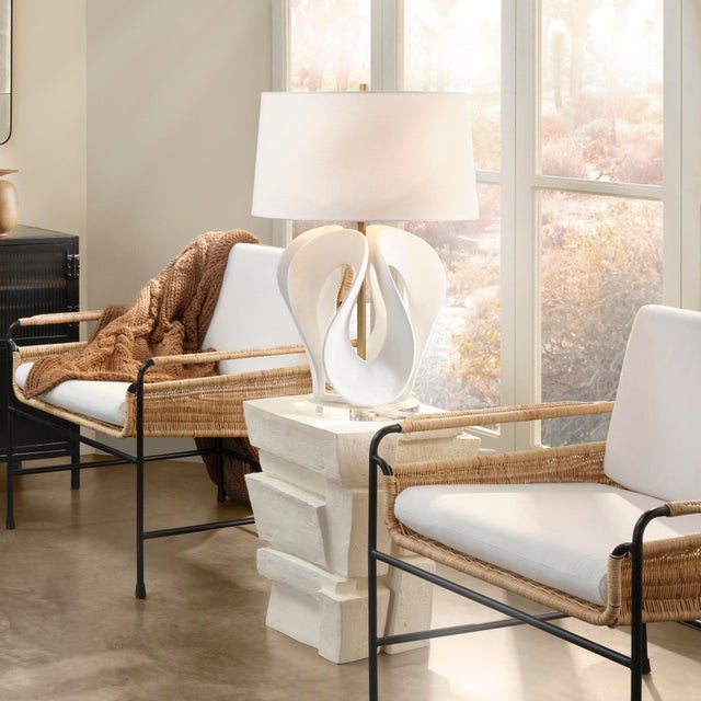 Soft swirls of pure resin dance around the base of this exquisite table lamp, suggesting the majestic curve of a swans...