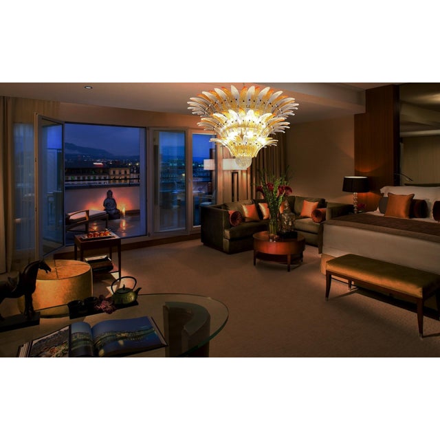 Palmette ceiling light made by 104 Murano clear and amber glasses in a gold metal frame. Murano blown glass in a...