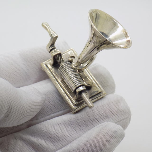 A captivating and mechanically inspired piece, this vintage Italian miniature represents a hand crank gramophone, crafted...