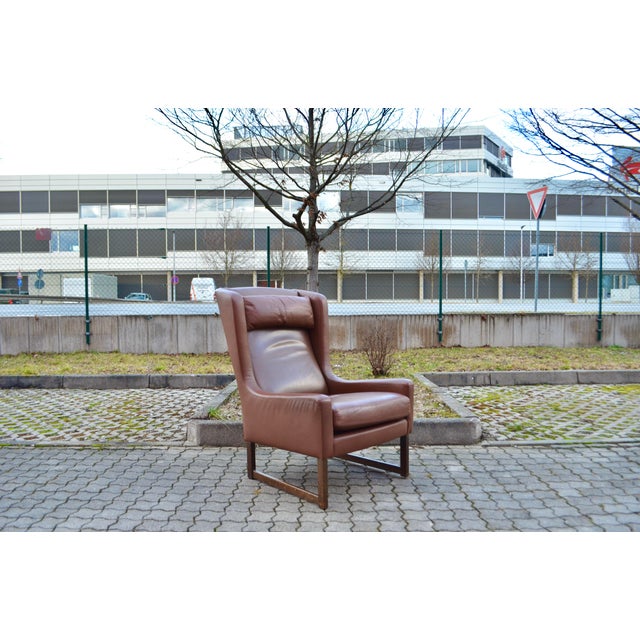 Kill International Leather Highback Lounge Chair design by Rudolf Bernd Glatzel. Cognac brown aniline leather. Walnut...