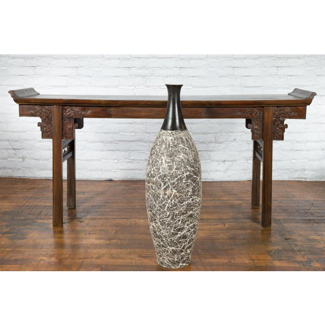 A tall contemporary Artisan Prem Collection vase from the 21st century with fluted mouth, black neck and white graffiti...