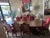 Beautiful inlaid wood dining table with double pedestal base. 8 chairs upholstered in a berry-red velvet front and brown...