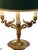 French Empire Bouilotte style Lamp from the mid 20th century made of brass or bronze. It has three arms in the form of...