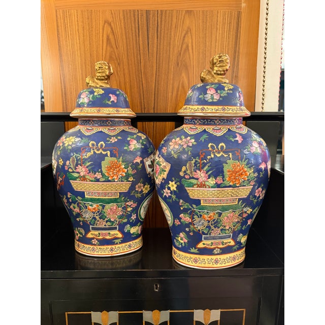 Pair of oval shaped porcelain ceramic Asian lidded vessels. Wonderful rich coloration with a blue background and wonderful...