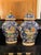 Pair of oval shaped porcelain ceramic Asian lidded vessels. Wonderful rich coloration with a blue background and wonderful...