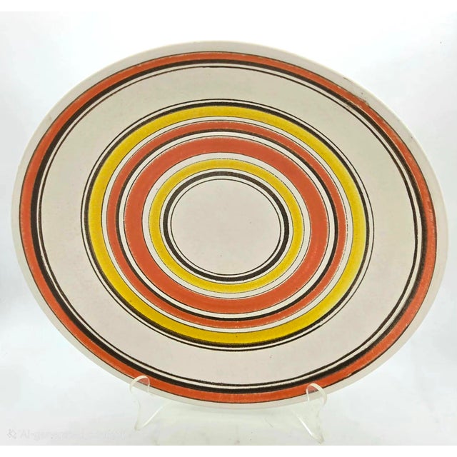 Offered is a mid 20th Century, circa. 1970s, glazed stoneware bowl or catch-all that has hand-painted concentric bands of...