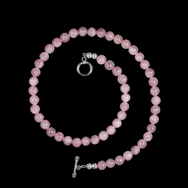 This elegant 18‑inch Madagascar Rose Quartz necklace showcases a strand of smooth, highly polished 8 mm beads that glow...