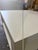 Handcrafted, beefy-leg coffee table. Made in the USA. Wrapped in an off-white Grasscloth textured material. Clear-coat...
