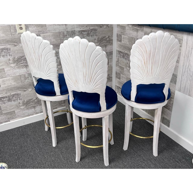 Set of 3 carved shell wood counter stools. The refreshed white wash and distressing highlights the carved shell backs. New...