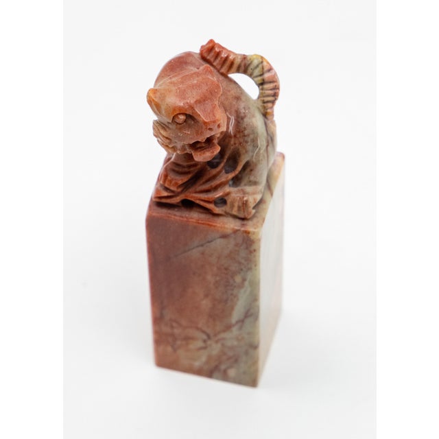 Offering a Chinese chop seal. Starts on thin square base that rises. Atop the seal is a guardian lion. All 4 sides are...