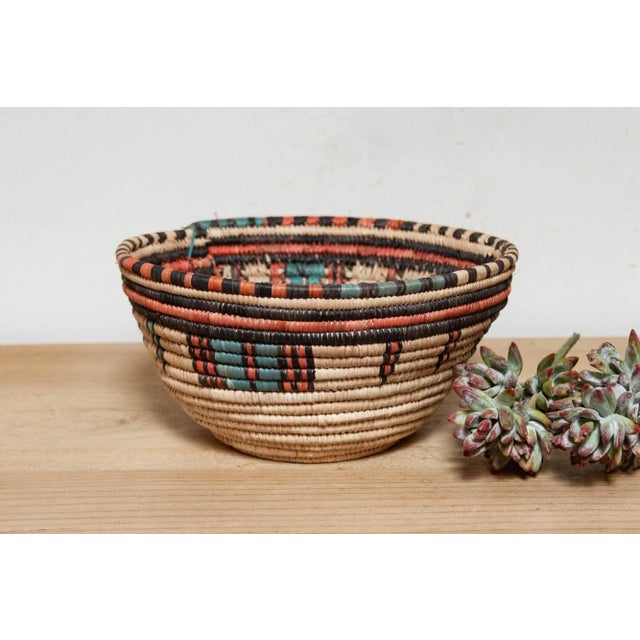This beautiful African woven grass basket is crafted by the Hausa women of Northern Nigeria. Each basket is meticulously...