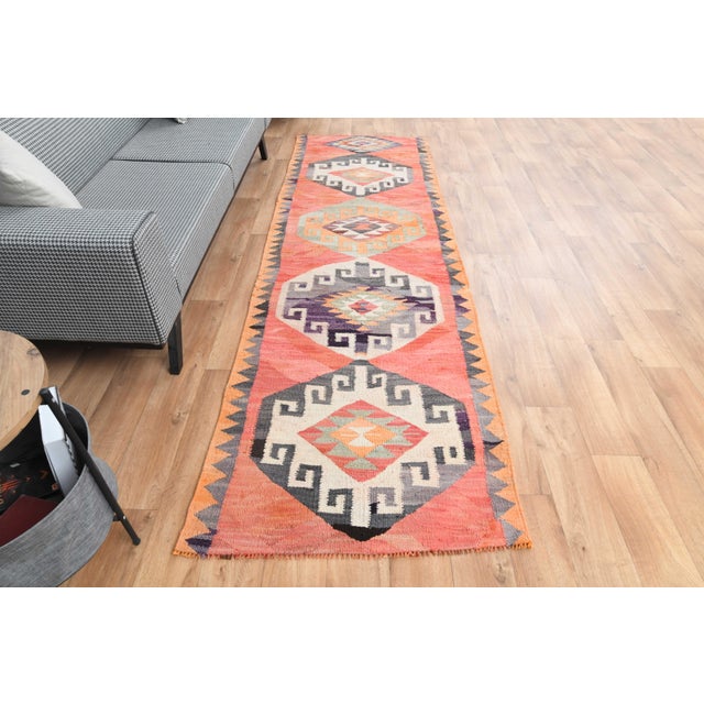 Vintage Hand-Knotted runner rug is a semi-antique vintage area rug. The '70s Eastern region of Anatolia's unique rug is...