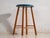 This antique wooden stool is a three-legged seat with a round seat and turned splayed legs joined by stretchers. It...