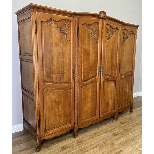 This elegant Vintage French Louis wardrobe presents classic craftsmanship with beautifully grained wood, refined panelled...