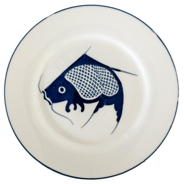 Beautiful set of eight vintage Chinese porcelain dinner plates featuring a bold, stylized koi fish motif in a classic deep...