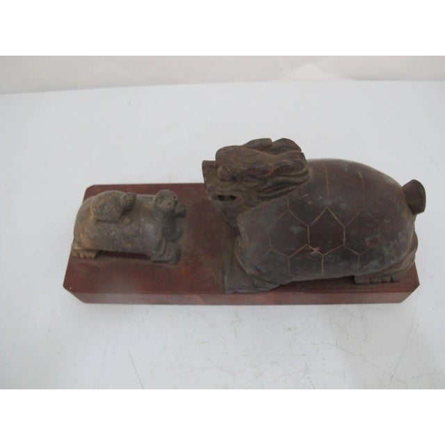 Chinese carved stone sculptures on base. A mythical dragon turtle faces a mother turtle with her baby on back. In Feng...