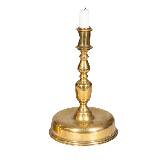 Pair Of European Baroque Brass Candlesticks Each with a candleholder with holes to punch out stub. Turned baluster and...