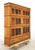 Early 20th century medium tone wood barrister bookcase with six sections, each with a lift and slide glass door. There are...