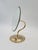 A stylish, decorative table mirror with an adjustable tilt angle, mounted on an elegant, wavy base. The entire piece is...