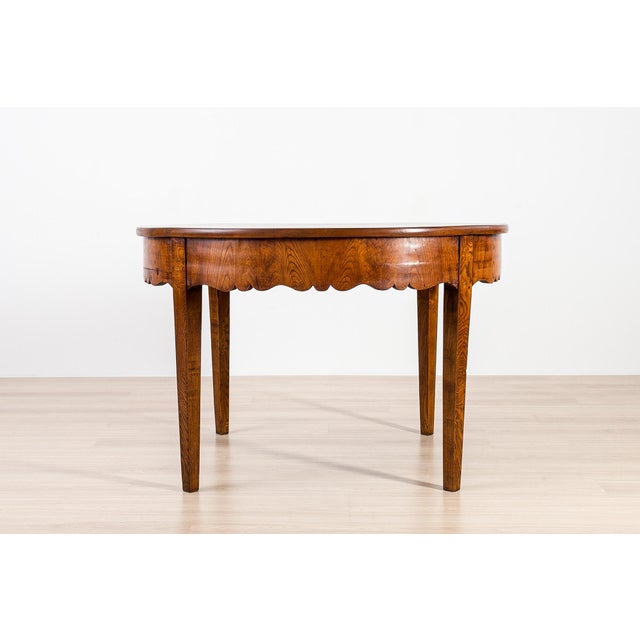 An exceptional and authentic Biedermeier dining table dating from the early 19th century, crafted from beautifully figured...