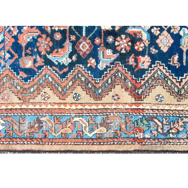 A stunning early 20th century Persian Serab rug with an incredible stylized floral pattern in the central field,...