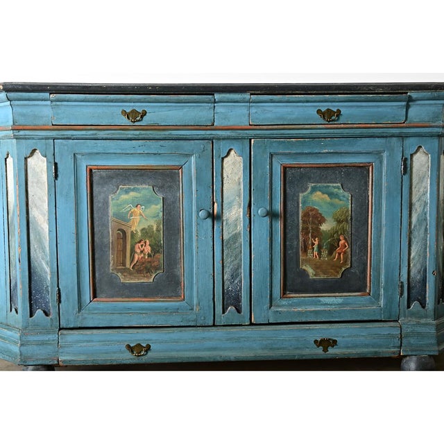 An endearing 18th century Italian hand-painted buffet that departs from the strong visual codes of the Baroque period...