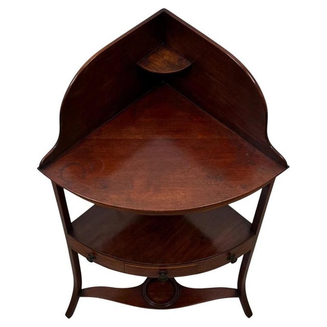 An elegant and beautifully proportioned 18th-century English Georgian corner stand, finely constructed in mahogany and...