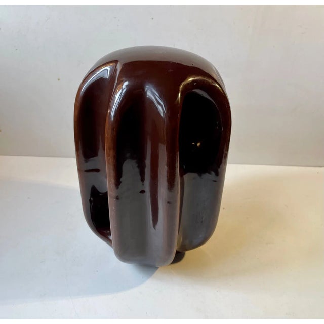 Weighing more than 10 kg this organically shaped odd looking porcelain object in brown glaze was originally installed as a...