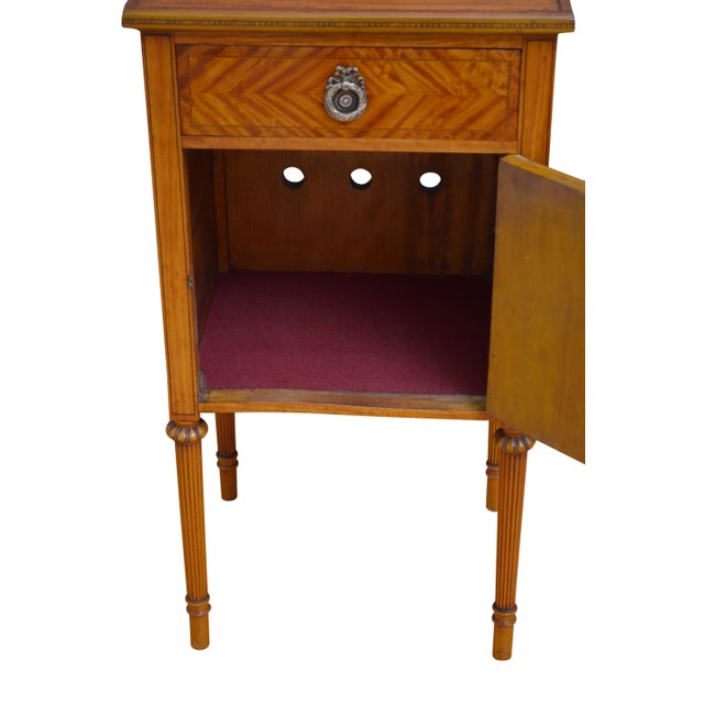 Fine Edwardian bedside cabinet in satinwood, having shaped upstand and inlaid top above a drawer and cupboard door both...