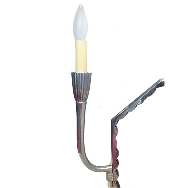 This elegant and unusual nickeled bronze wall mirror with electrified sconces was designed by Maurice Dufrêne, an...