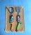 A wonderfully whimsical pair of vintage Memphis-style salad servers featuring sculptural ceramic handles depicting a man...