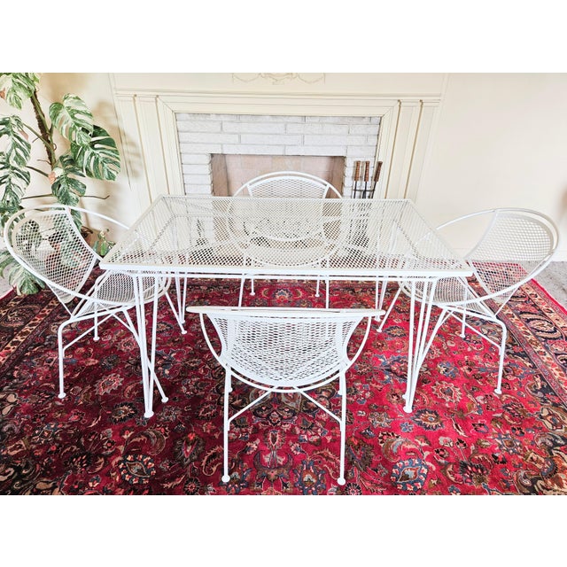 An Original MCM Atomic Radar Santorini Style Set Wrought Iron Table And Chair 5 Piece Set. The Radar chairs measure: Radar...