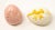 Offering a pair of ceramic glazed eggs. One is pink with speckles with a leaf stamped in the side. The other egg is cream...