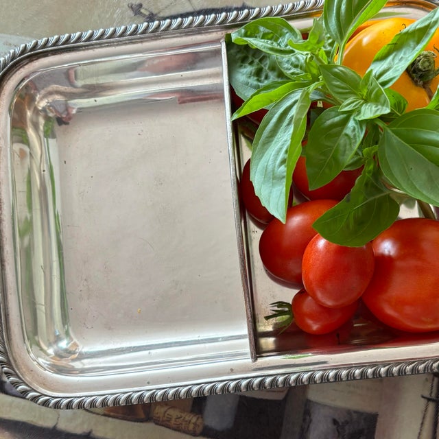 Add classic elegance to your tablescape with this vintage silver-plated divided serving tray. Featuring two deep sections,...