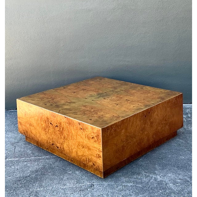 This striking coffee table is a masterclass in 1970s Hollywood Regency glamour. It features a bold, oversized plinth form...