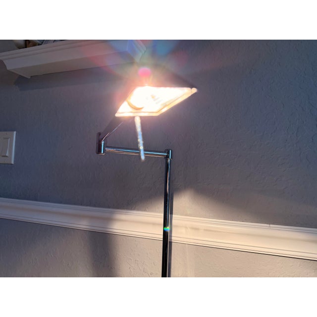 An exceptional example of late 20th-century Italian functionalist design. This sleek swing arm adjustable floor lamp...