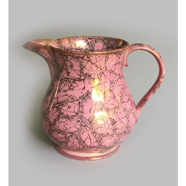 Staffordshire unusual pink lustre jug decorated with transfer printed with black outlined various sized leaves. Marked...