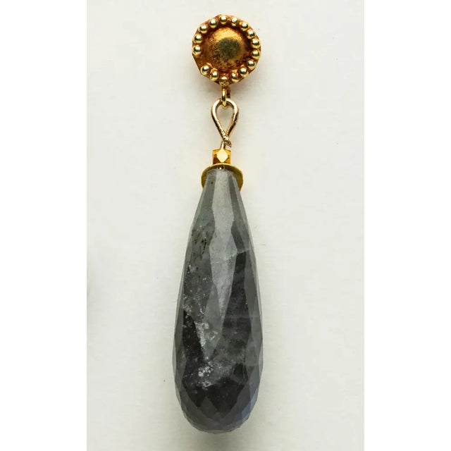 A lovely pair of faceted, long briolette labradorite drop earrings with an 18K gold leaf-motif over the top and 18K gold...
