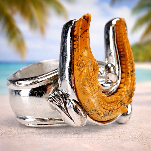 A set of 4 Hans Turnwald silverplated napkin rings featuring nature-inspired motifs. Each piece is constructed with a...