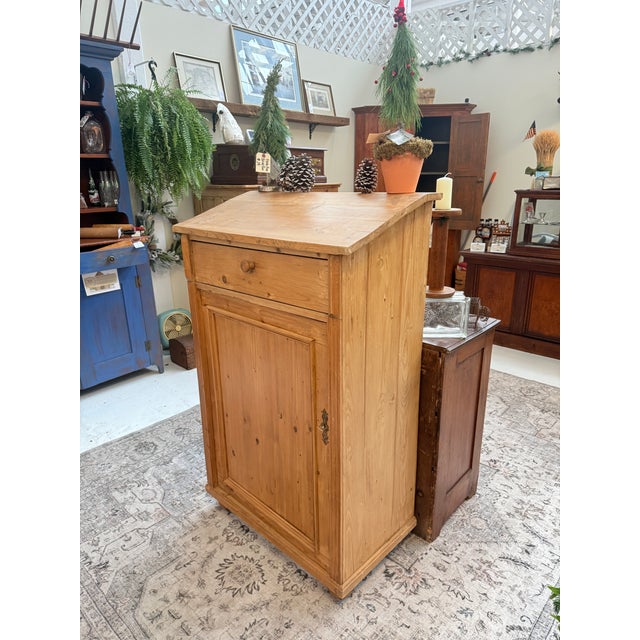 Crafted in warm, honey-toned pine, this English country cabinet embodies rustic charm and practical elegance. Its design...