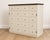 Beautifully refinished French Provincial apothecary-inspired cabinet featuring an elegant sculpted ivory finish paired...