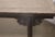 A handsome antique Chinese bench crafted from solid elmwood, dating to the late Qing dynasty. The substantial plank seat...