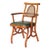 Vintage rattan armchair with caned backrest and green vinyl seat.