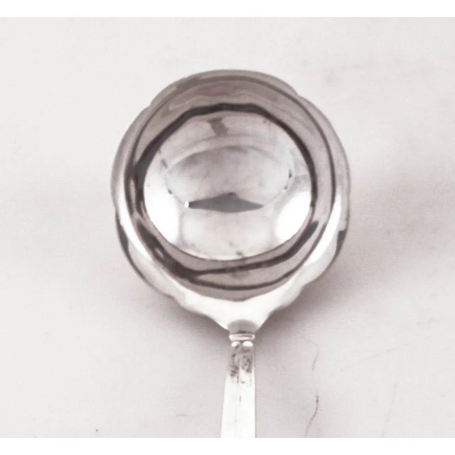 We are offering this sterling silver gravy ladle in the Celtic Weave pattern by Towle Silversmiths. It has a Jensenesque...