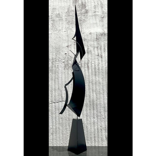 This vintage boho monumental abstract sculpture is made from steel and showcases a dynamic, flowing design with sleek...