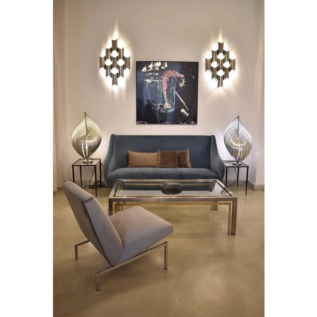 Pair of Italian chrome wall sconces by Reggiani, dating to the 1970s. Their bold arrangement of polished tubular metal...