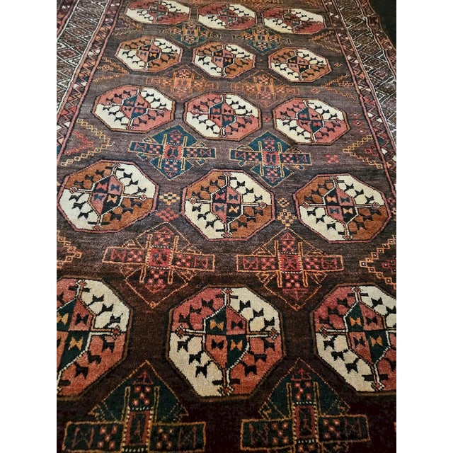 Authentic hand-knotted Baluchi rug, crafted from wool and featuring an elegant tribal design composed of regular rows of...