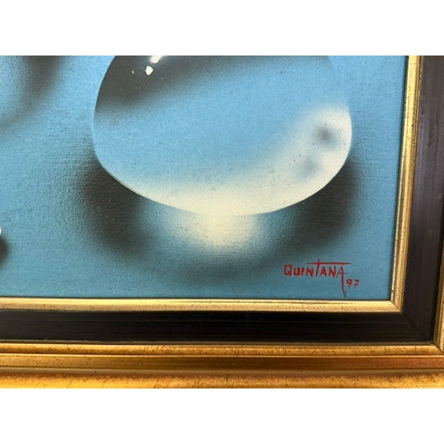 Quintana's composition features two delicate birds surrounded by hyper‑realistic water droplets that appear to float above...
